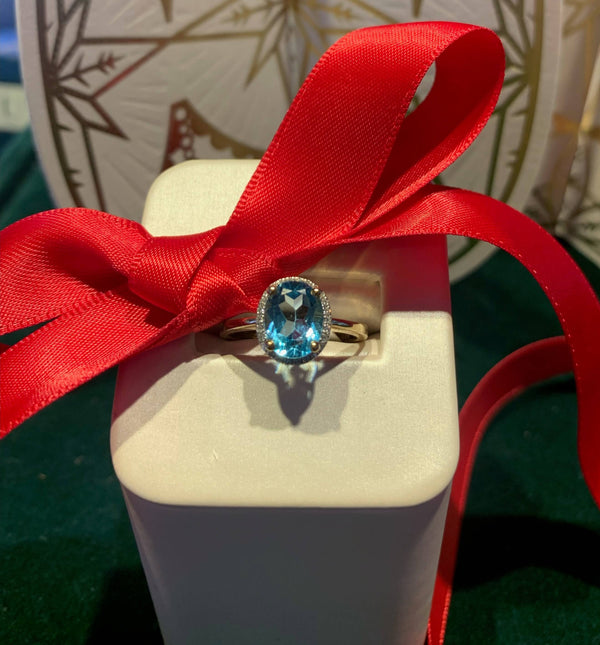 topaz stud ring on display with red bow 